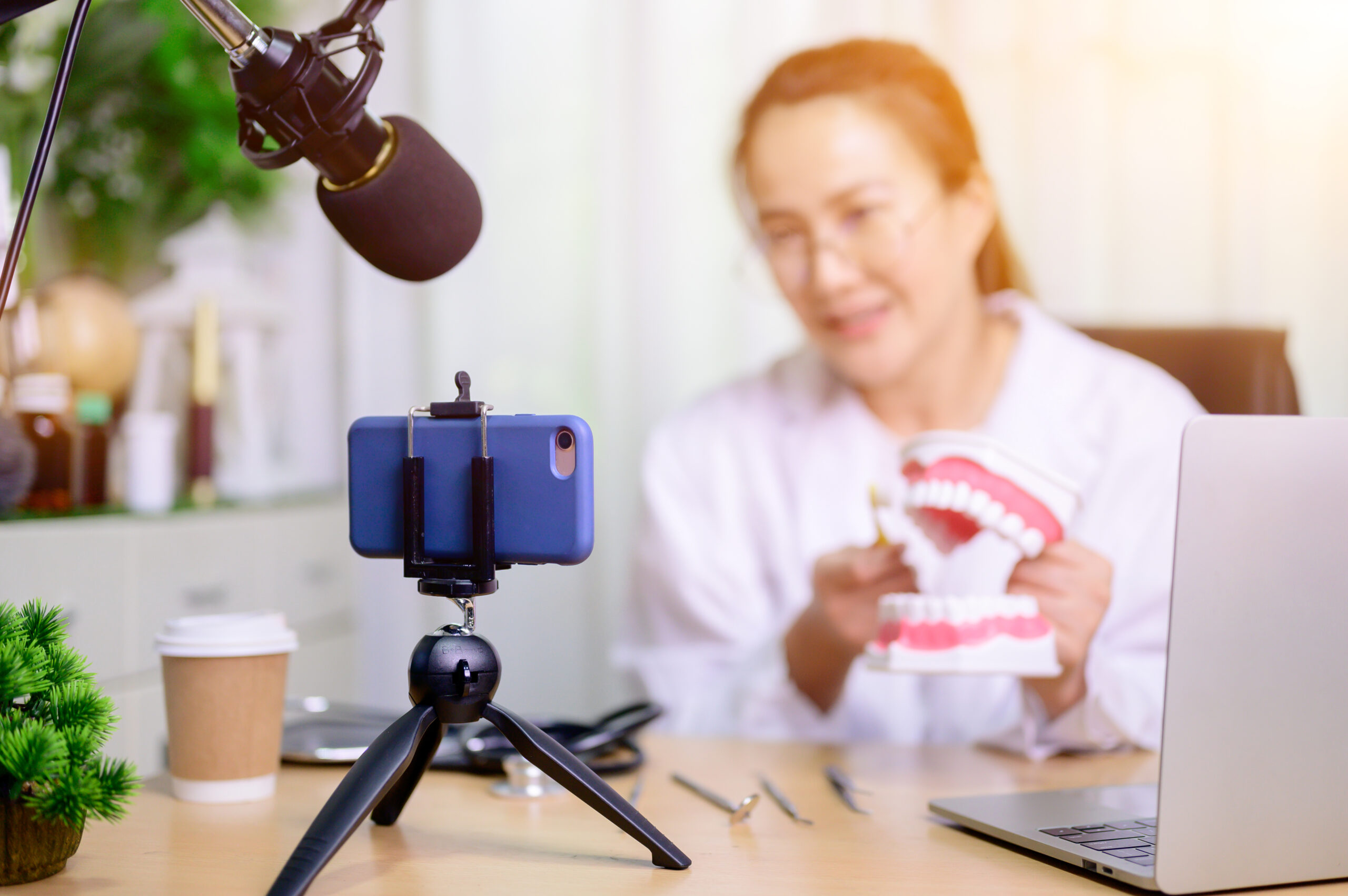 Dentist recording video for social media.