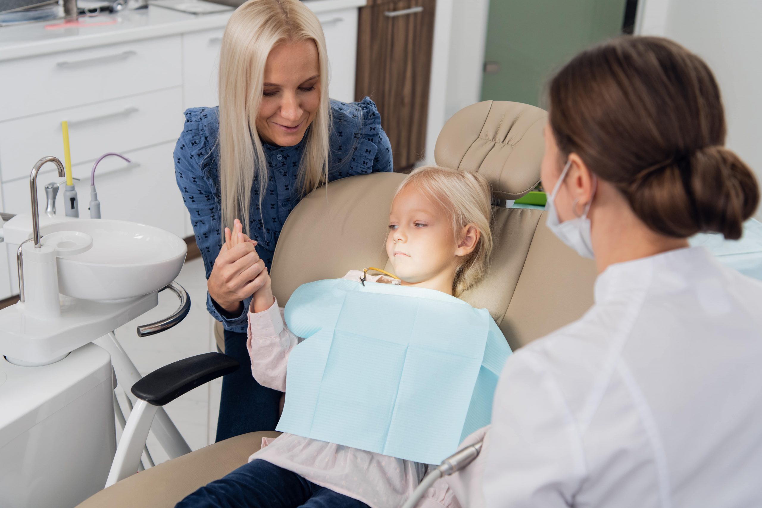 Parent with their scared child at the dentist.