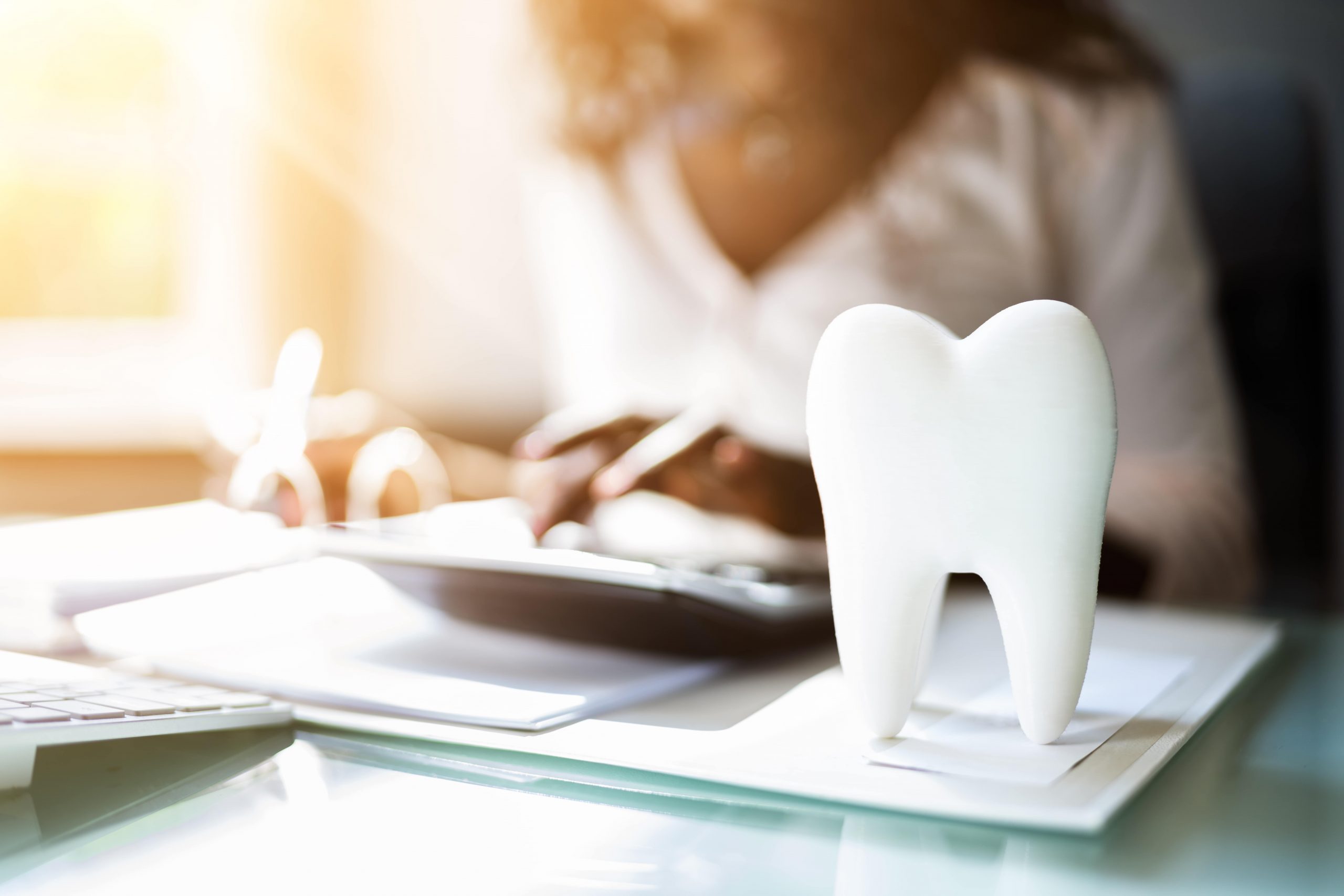 Dentist calculating cost of malpractice insurance